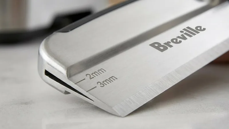Close-up detail of the Breville razor tool showing the precision trimming blade and depth markings