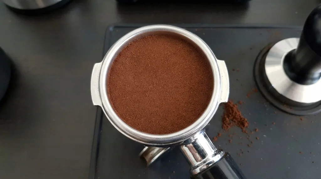 Level and flat coffee puck after tamping in a portafilter